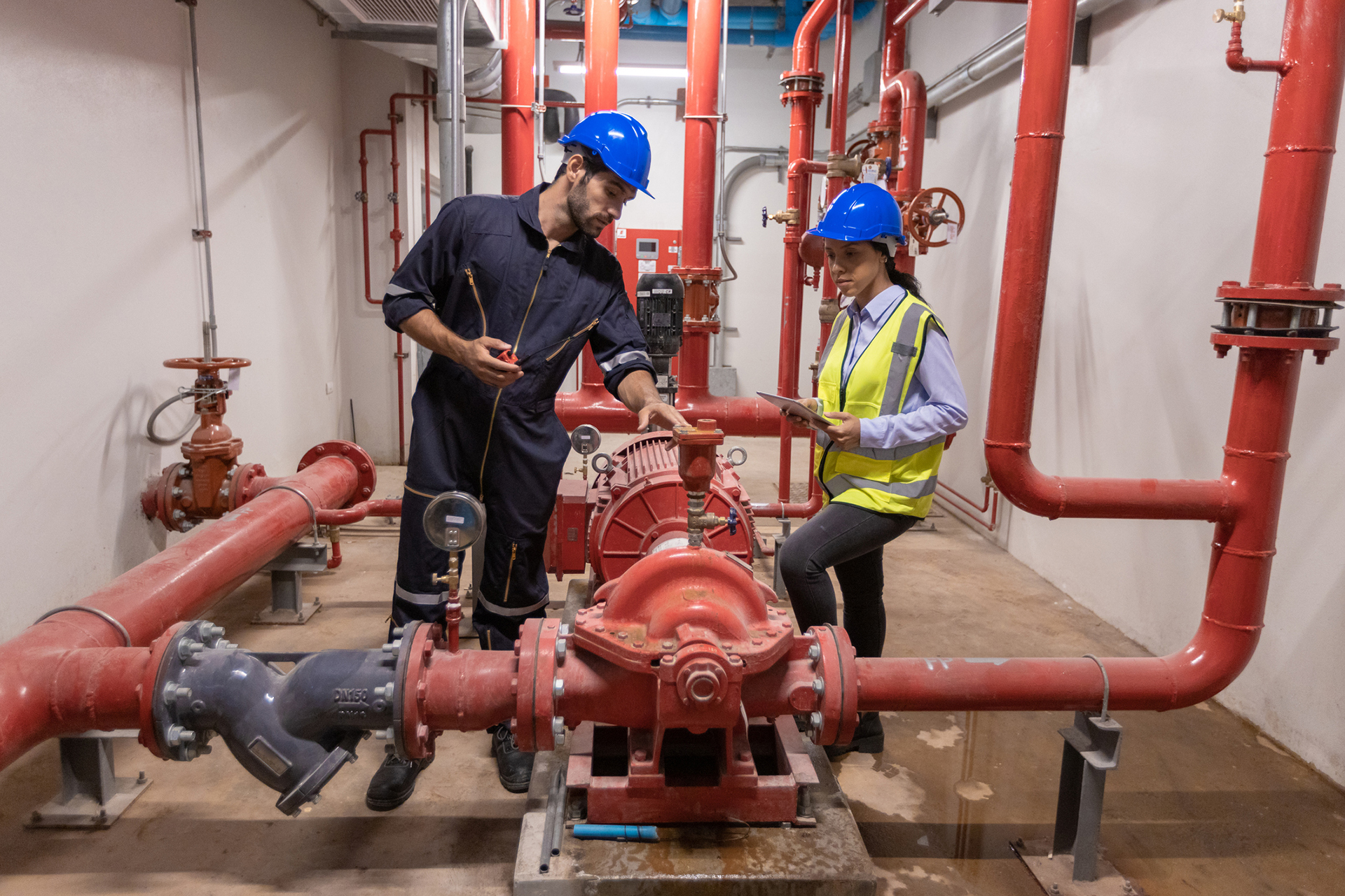 Engineer under checking the industry chilled water fan coil unit air conditioner is water cooling tower air chiller HVAC system of large industrial building to control air system